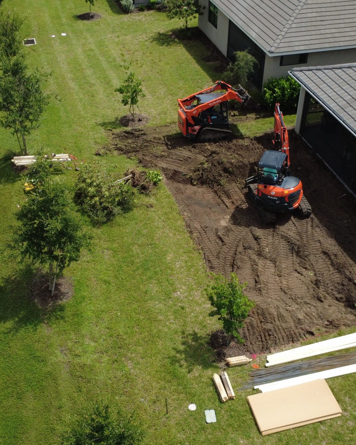 Aerial view of Eco Site Works grading a residential lot with Kubota equipment