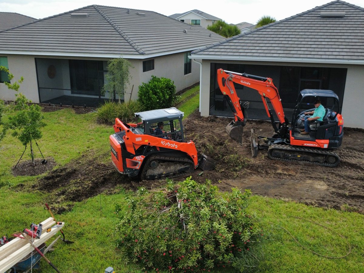 Eco Site Works Kubota track loader and mini excavator grading a residential lot in Manatee County
